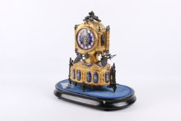 An unusual late 19th century French cast metal and ormolu mantel clock.