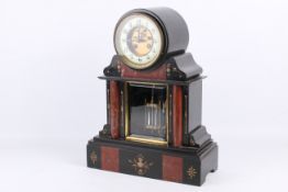 A 19th century French black slate and red marble cased mantel clock.