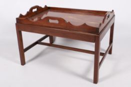 An early 20th century Georgian style mahogany butler's tray on a stand.