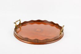 An Edwardian mahogany circular tray.