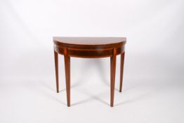 A Georgian mahogany demi-lune fold over top card table.