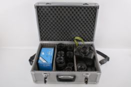 A Praktica B100 35mm SLR camera and assortment of bayonet Praktica mount lenses.