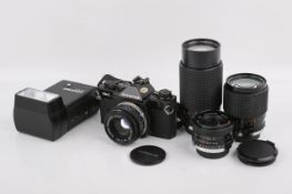 An Olympus OM-2 Spot/Program 35mm SLR camera outfit. Black. Serial number 1103634.