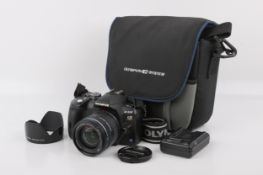 An Olympus E-510 Digital SLR camera. With an Olympus 14-42mm f3.5-5.6 Zuiko Digital lens, optics G.