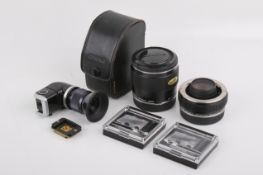An assortment of Olympus OM camera accessories.