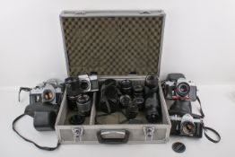 A mixed collection of M42 35mm SLR cameras and lenses.