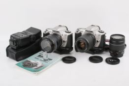 Two Canon EOS 300 35mm SLR cameras. Both Silver. With three lenses; a Canon Zoom EF 28-105mm f3.5-4.