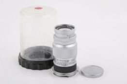 A Leitz 9cm f4 Elmar lens. Leica M-mount. Chrome. Serial number 1498696. Optics F, haze.