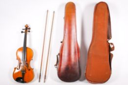An early 20th century violin with two bows and case. Unlabelled, a 358mm two piece back.