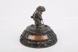 A bronze golfing trophy in the form of a rabbit.