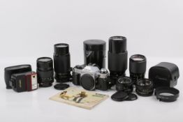 A Canon AE-1 Program and assorted FD lenses. Chrome. Serial number 1660320.