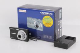 An Olympus FE-360 compact digital camera. Black. Powers on, shutter working.
