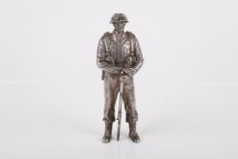 A cast silver WWII paratrooper figure.
