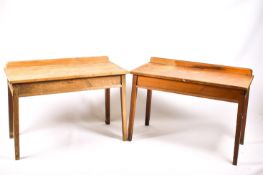 A pair of vintage pine work tables.