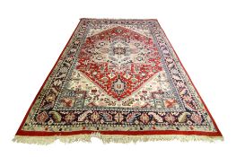 A late 20th century large Persian rug.