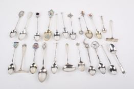 A collection of silver and white metal teaspoons.
