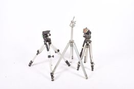 A vintage aluminium camera tripod with a Manfrotto #136 head and two others.