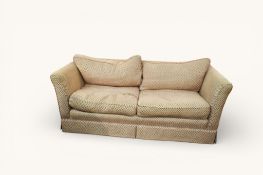 A contemporary two seater low back sofa with spot pattern upholstery. Having feather cushions.