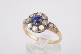 A sapphire and diamond dress ring (damaged). With a round cut central sapphire of circa 4.