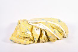 Three pairs of lined and pleated, yellow curtains with birds in foliage pattern.