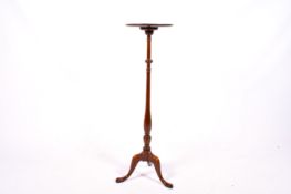 A 20th century Georgian style mahogany tripod pedestal plant stand.