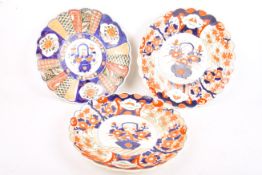 Three scalloped edge Japanese ceramic chargers.