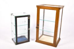 Two vintage glazed counter top shop display cabinets.