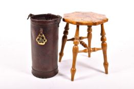 A Burwood stool and a reproduction leather stick stand.