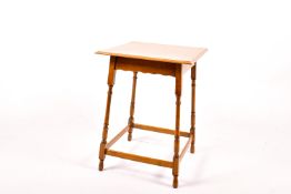 An oak side table labelled Waring & Gillow.