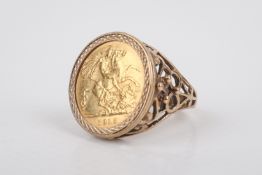 A half sovereign coin ring. The coin dated 1915, presented in a hallmarked 9ct gold mount.