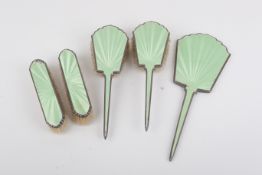 A five piece enamel and silver dressing table set.
