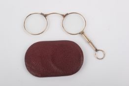 A pair of yellow metal framed lorgnettes.
