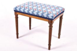 An upholstered dressing table stool with fixed legs. Having fluted tapering supports.