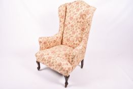 An early 20th century wingback armchair.