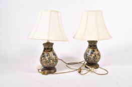 Pair of modern Chinese style ceramic baluster table lamps with shades. Raised on circular bases.