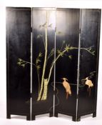 A 20th century Chinese lacquer four fold screen. Depicting figures in the landscape.