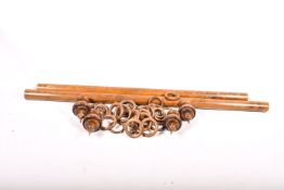 Two large pine curtain poles with rings.