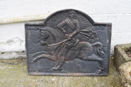 A large fireback with horse and rider, dated 1649.