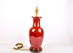 A contemporary Chinese sang de boeuf vase table lamp. Raised on a turned wooden base.