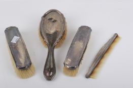 A George V silver backed dressing table set and a silver handled comb.