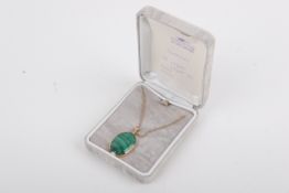 A 9ct gold mounted malachite pendant and chain. The oval cabochon pendant measuring 2.5cm x 1.
