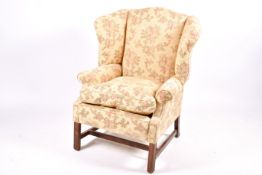 A 20th century Queen Anne style wingback armchair.
