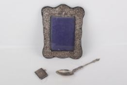 A group of three hallmarked white metal items. Including a vesta case and a spoon, etc.