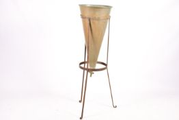 Copper verdigris percolator funnel with brass tap on an iron tripod stand.