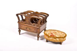 A stained pitch pine Canterbury style magazine rack and an embroidered footstool.