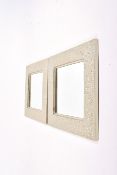 A pair of contemporary square cast metal framed wall mirrors.