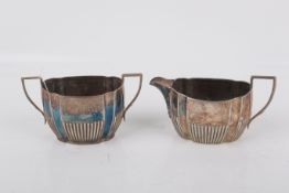 An Edwardian silver sugar pot and cream jug.