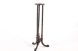A black painted wood torchière stand.