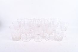 Collection of assorted drinking glasses. Including two tumblers and two sets of seven wine glasses.