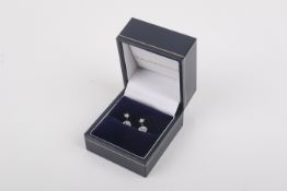 A pair of 18ct white gold and diamond stud earrings. Having screw backs, 0.9g gross.